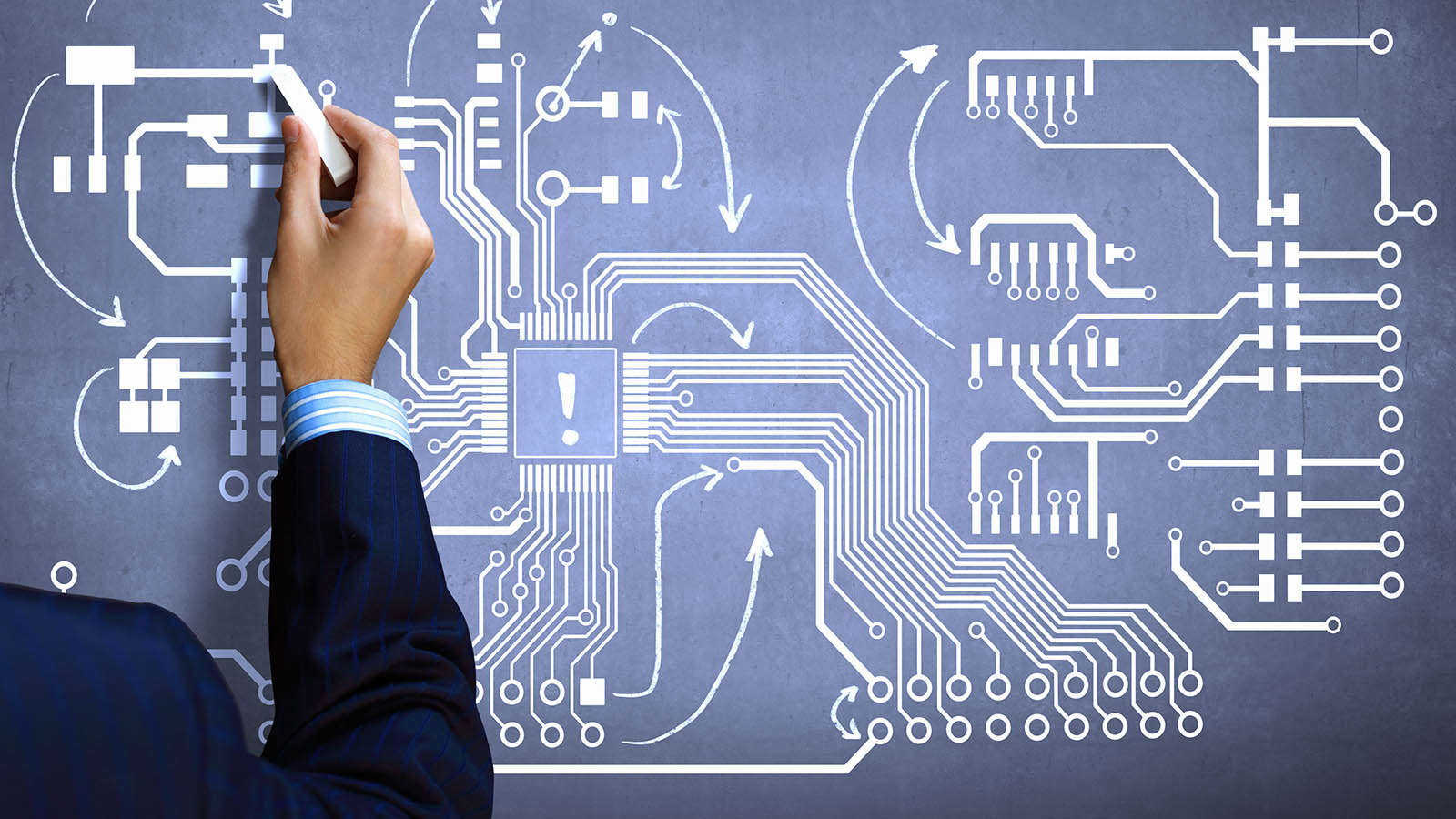 Arm with chalk in hand sketches a PCB design